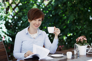 Young cute woman drinks coffee.