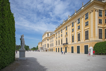 Obraz premium Vienna, Austria, April, 30, 2018. Tourists walk around the Royal Palace Schoenbrunn in Vienna, Austria. This Palace was the summer residence of Austrian Emperors.