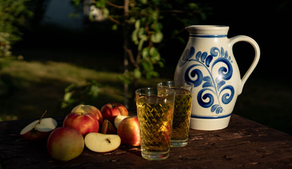 Traditional apple wine in the city of Frankfurt in Hesse. A jug of wine is on an old wooden table...