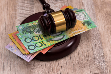 Australian dollars under judge's gavel close up