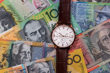 Wrist watch on australian dollars banknotes as background