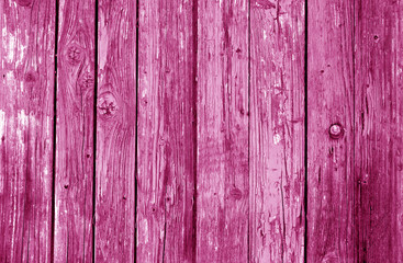 Old grunge wooden fence pattern in pink tone.