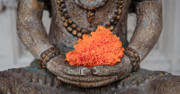 Buddha with orange flower