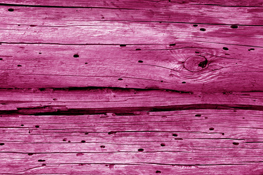 Old grunge wooden fence pattern in pink tone.