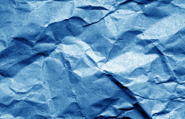 Old crumpled paper with wrinckles in navy blue color.