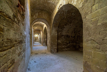 Fototapeta na wymiar Stone arches in old fortess, perspective, passageway, Totleben fortess near Kerch