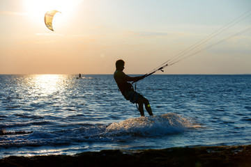 professional kiter doing a complicated trick on a beautiful sunset background