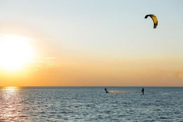 professional kiter doing a complicated trick on a beautiful sunset background