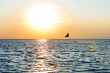 professional kiter doing a complicated trick on a beautiful sunset background