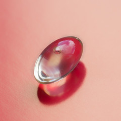 Gelatin capsules on pink background. Closeup