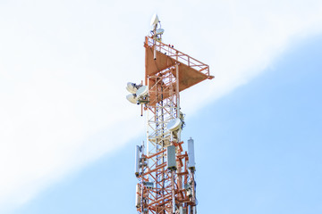 Cellular telecommunication tower and radio, blue and cloudy sky background