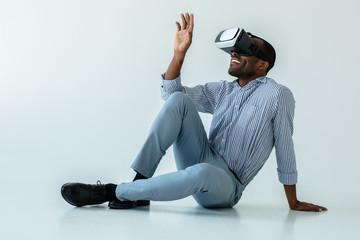 Positive afro american man wearing VR glasses