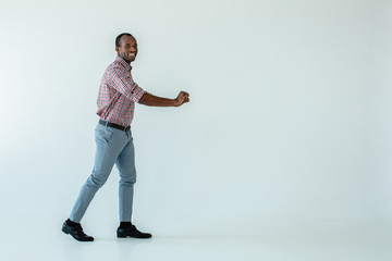 Positive afro american man holding a cart