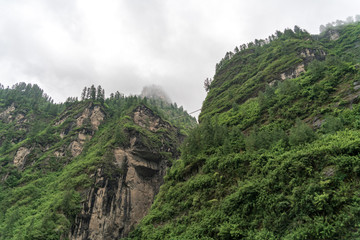 A high suspension bridge near the clouds above the main trail of the Annapourna Circuit