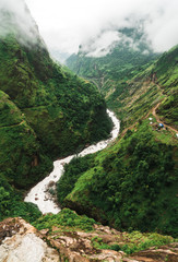 Light peaks through some dense rainy season clouds on the Annapurna Circuit
