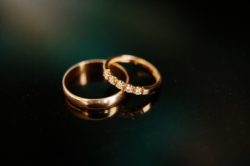 gold wedding rings on black background