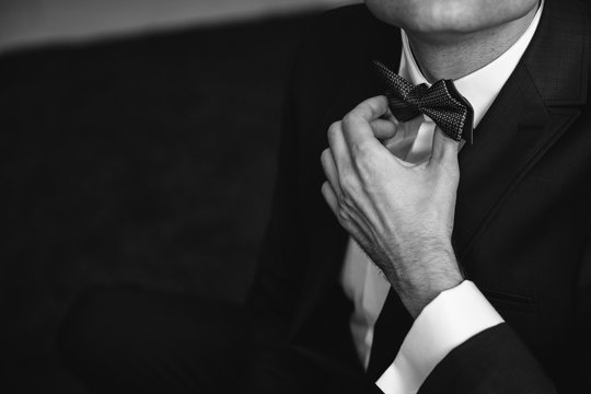 A man's hand in a suit setting time close-up. White color control mode serious work Secretary of student the luxury of a formal interview executiveagent marriage stone corporate elegance employment 
