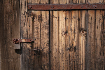 old abandoned locked door with rusty padlock.
