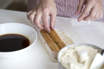 Fototapeta na wymiar Tiramisu making. process of ice cream-tiramisu preparation.