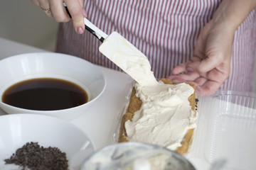 Obraz na płótnie Canvas Tiramisu making. process of ice cream-tiramisu preparation.
