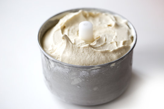 Just made homemade ice cream. Frezer is open and dasher is being pulled out.