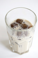 Iced coffee cocktail or frappe with ice cubes and cream