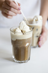 Iced coffee cocktail or frappe with ice cubes and cream