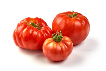 Colorful red tomatoes of different sizes and kinds isolated on white background