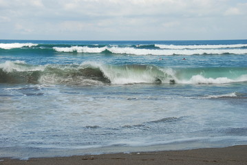 The coast of Pantai Batu Bolong Beach and sea with huge waves, south Bali, Indonesia 