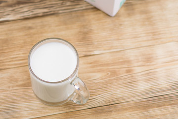 Glass kefir (milk) on a wooden background. The concept of diet, weight loss.