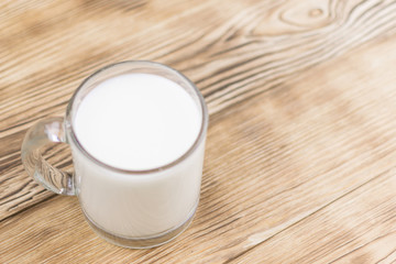 Glass kefir (milk) on a wooden background. The concept of diet, weight loss.