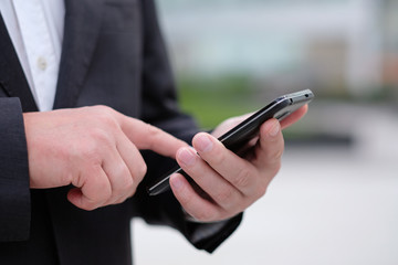 Close up of hands holding smartphone. Business technology concept