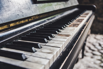Old abandoned broken piano on the street
