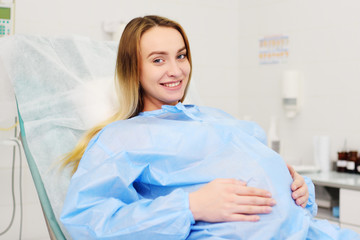 pretty pregnant woman in the delivery room. Childbirth, prenatal labor, attempts.