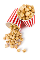 Tasty popcorn in striped paper cups, isolated on white background