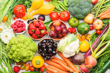 Summer fruits vegetables berries background, apples cherries peaches strawberries cabbage broccoli cauliflower squash tomatoes carrots spring onions beetroot, top view, selective focus