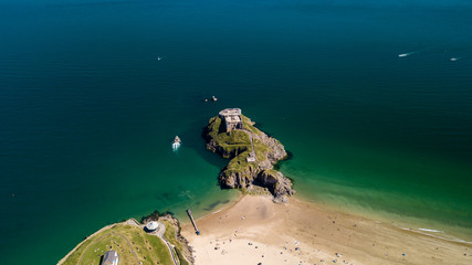 Aerial drone view of an old, historic fort on a small island off a picturesque, colorful coastal town (St Catherine, Tenby)
