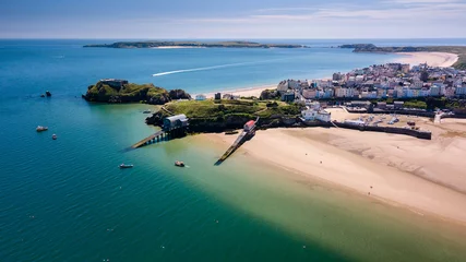 Fotobehang Aerial drone view of a beautiful coast town with sandy beaches and colorful buildings (Tenby, Wales, UK) © whitcomberd
