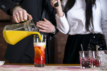 bartender at bar prepares a cocktail of beer and juice