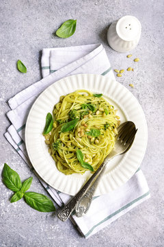 Spaghetti pasta with basil pesto and pine nuts.Top view with copy space.