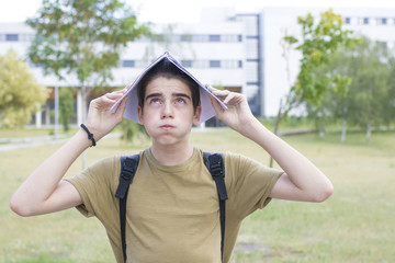 stressed or overwhelmed student with notebook on head