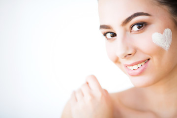 Obraz na płótnie Canvas Skincare. Woman With Healthy Face Applying Cosmetic Cream Under The Eyes