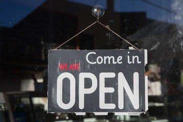 Open Sign Hanging in the Window of a Cafe