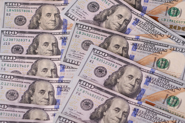 Background of 100 dollar bills. a pile of American paper hundred-dollar bills as an element of the world financial system