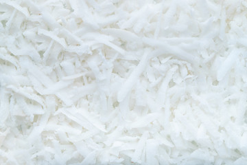 Fresh coconut flakes background. Top view. closeup.