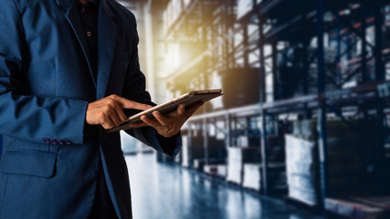 Businessman manager using tablet check and control for workers with Modern Trade warehouse...