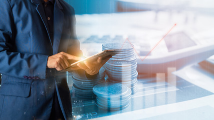 Businessman finger touching tablet with finance report  of growth investment