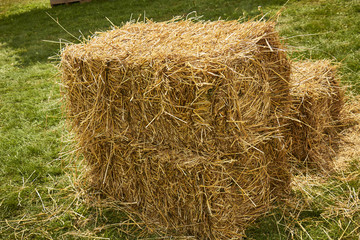 A square hay bale made from antique farm machinery