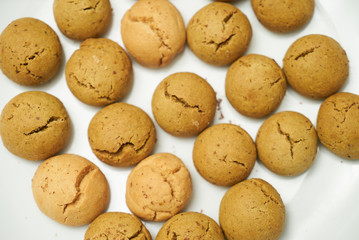 Cookies and sweet biscuits on white plate background, top view 