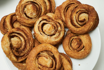 Cookies and sweet biscuits on white plate background, top view 